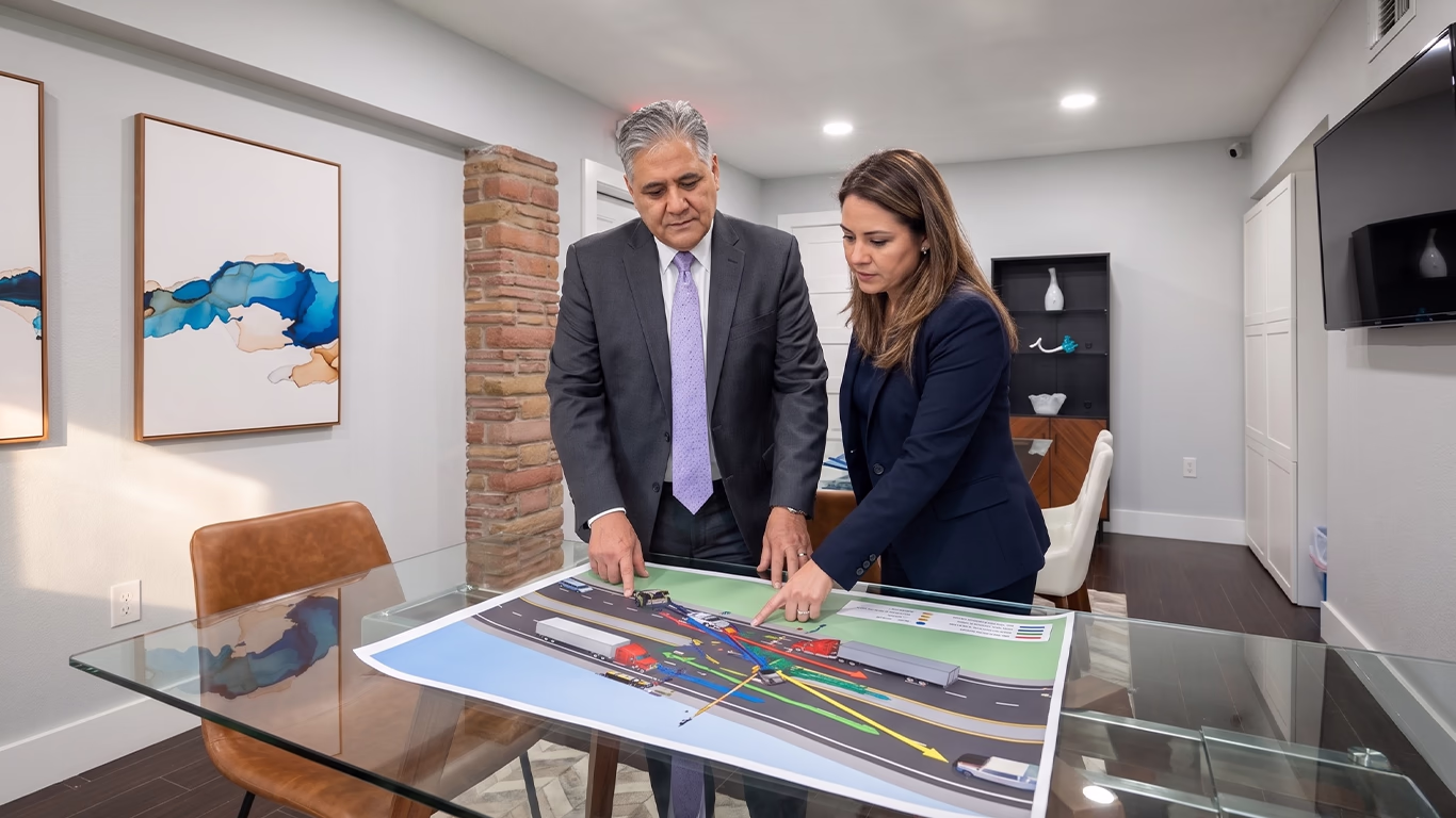 Orlando truck accident lawyer discussing a commercial vehicle crash reconstruction and legal strategy with a client in a Florida law office.